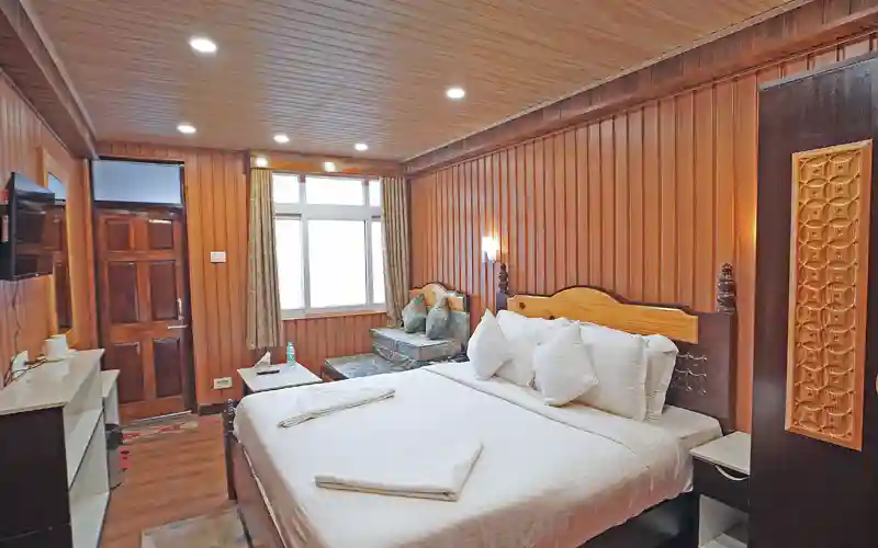 Sher E Bengal hotel room featuring elegant wooden interiors and modern lighting